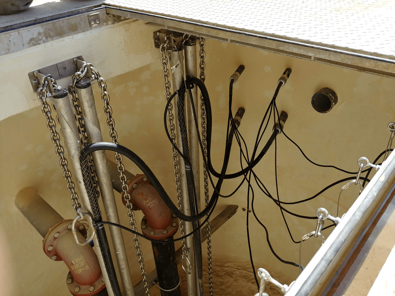 interior-of-wet-well-with-discharge-piping-and-guide-rails Wet Well Connections for Electrical Components and Discharge Piping
