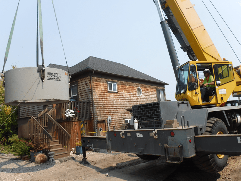 Crane Installing Concrete Wet Well for New Lift Station