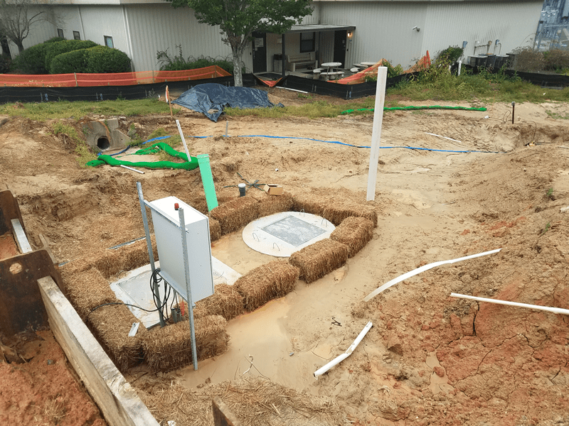 Hay Bales Being Used to Prevent Surface Flows from Entering Pump Station