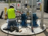 A technician examining a skid