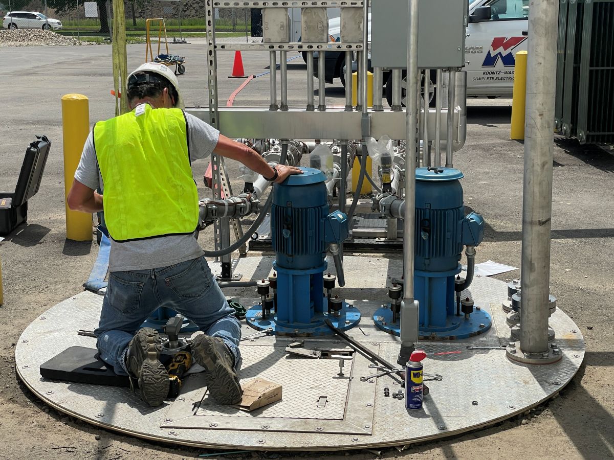 A technician examining a skid