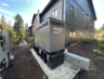 The generator and control panel for the apartment wastewater lift station on the backside of the Creekside Village apartments in Vashon Island, Washington.